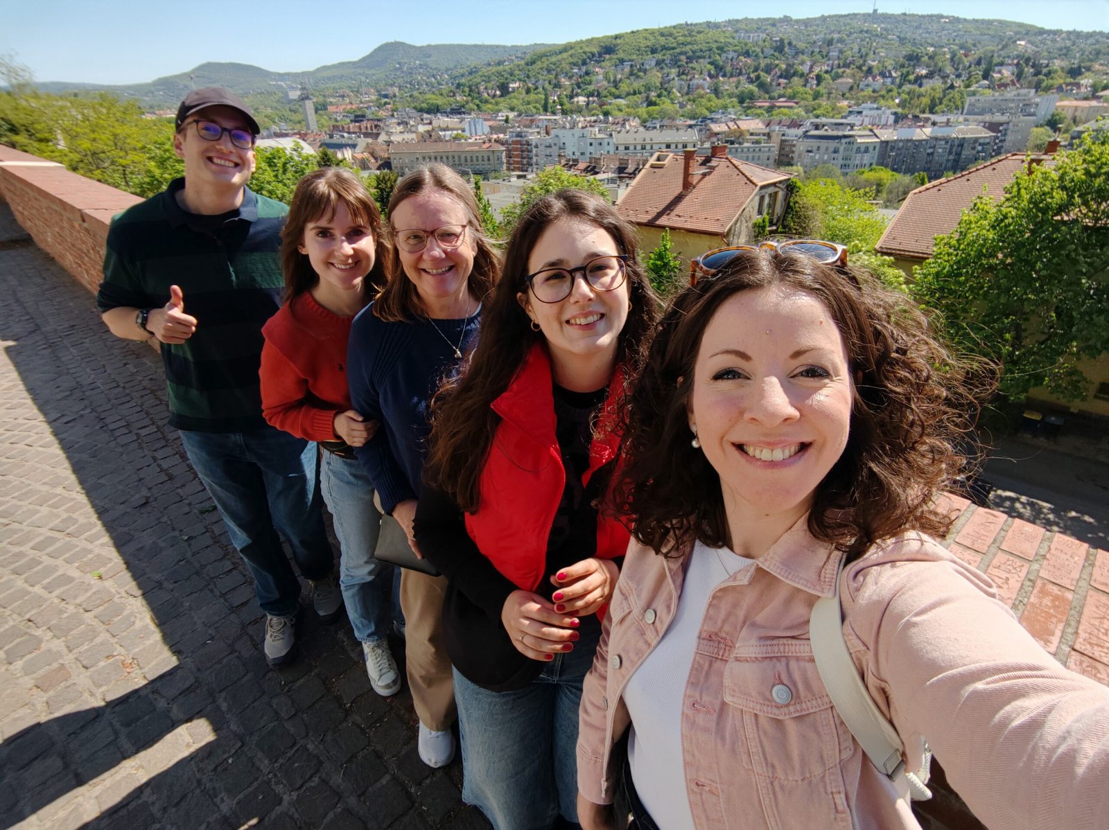Guests enjoying a private walking tour in Budapest's historic Buda Castle District with panoramic city views and a licensed local guide.